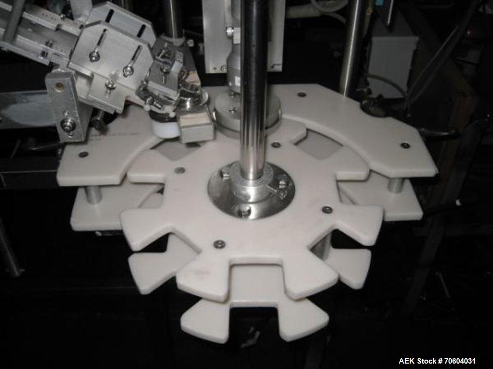 Used Kalish Starcap Automatic Chuck Capper. Capable of speeds up to 80 bottles per minute. Cap size range: 13mm to 58mm with changeparts. Currently set up on 43mm diam caps. Has a vibratory bowl feed...