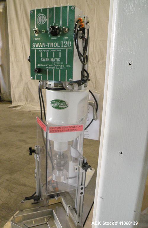Used Swan-Matic Cap Master Single Cycle Bench Top Capper, Model C-300. Up to 40 strokes per minute. Driven by a  1/4 hp, 0-100 volt, 1800 rpm motor. Adjustable height for up to 13" tall containers. C...