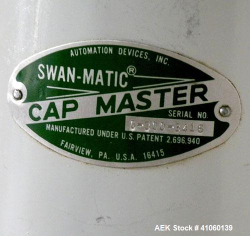 Used Swan-Matic Cap Master Single Cycle Bench Top Capper, Model C-300. Up to 40 strokes per minute. Driven by a  1/4 hp, 0-100 volt, 1800 rpm motor. Adjustable height for up to 13" tall containers. C...