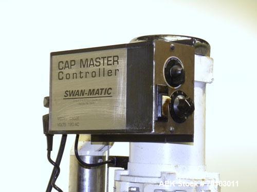 Used Swan-Matic Cap Master Single Cycle Bench Top Capper, Model C300. Up to 40 caps per minute. Driven by a 1/4 hp, 90 volt, 1750 rpm DC motor with a Swan-Matic model C302E controller. Manual adjusta...