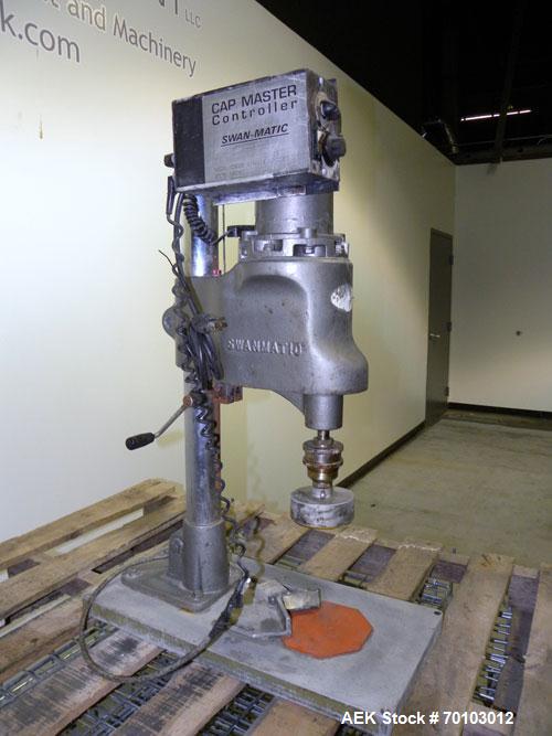 Used Swanmatic Cap Master Single Cycle Bench Top Capper, Model C300. Up to 40 caps per minute. Driven by a 1/4 hp, 90 volt, 1750 rpm DC motor with a Swan-Matic model C302E controller. Manual adjustab...