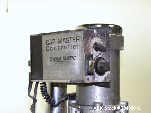 Used Swanmatic Cap Master Single Cycle Bench Top Capper, Model C300. Up to 40 caps per minute. Driven by a 1/4 hp, 90 volt, 1750 rpm DC motor with a Swan-Matic model C302E controller. Manual adjustab...
