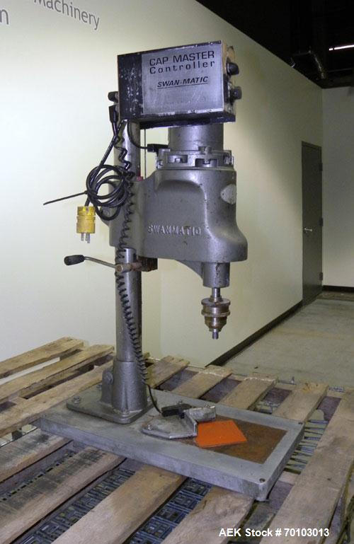 Used Swan-Matic Cap Master Single Cycle Bench Top Capper, Model C300. Up to 40 caps per minute. Driven by a 1/4 hp, 90 volt, 1750 rpm DC motor with a Swan-Matic model C302E controller. Manual adjusta...