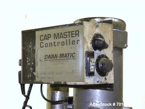 Used Swan-Matic Cap Master Single Cycle Bench Top Capper, Model C300. Up to 40 caps per minute. Driven by a 1/4 hp, 90 volt, 1750 rpm DC motor with a Swan-Matic model C302E controller. Manual adjusta...
