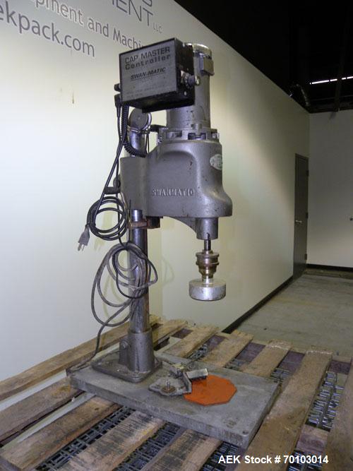 Used Swan-Matic Cap Master Single Cycle Bench Top Capper, Model C300. Up to 40 caps per minute. Driven by a 1/4 hp, 90 volt, 1750 rpm DC motor with a Swan-Matic model C302E controller. Manual adjusta...