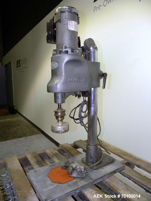 Used Swan-Matic Cap Master Single Cycle Bench Top Capper, Model C300. Up to 40 caps per minute. Driven by a 1/4 hp, 90 volt, 1750 rpm DC motor with a Swan-Matic model C302E controller. Manual adjusta...