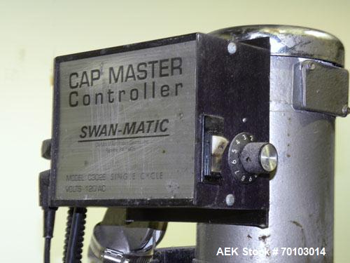 Used Swan-Matic Cap Master Single Cycle Bench Top Capper, Model C300. Up to 40 caps per minute. Driven by a 1/4 hp, 90 volt, 1750 rpm DC motor with a Swan-Matic model C302E controller. Manual adjusta...