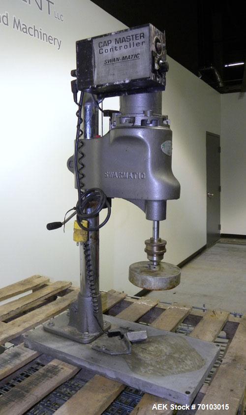 Used Swan-Matic Cap Master Single Cycle Bench Top Capper, Model C300. Up to 40 caps per minute. Driven by a 1/4 hp, 90 volt, 1750 rpm DC motor with a Swan-Matic model C302E controller. Manual adjusta...