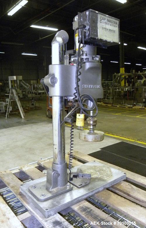 Used Swan-Matic Cap Master Single Cycle Bench Top Capper, Model C300. Up to 40 caps per minute. Driven by a 1/4 hp, 90 volt, 1750 rpm DC motor with a Swan-Matic model C302E controller. Manual adjusta...