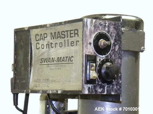 Used Swan-Matic Cap Master Single Cycle Bench Top Capper, Model C300. Up to 40 caps per minute. Driven by a 1/4 hp, 90 volt, 1750 rpm DC motor with a Swan-Matic model C302E controller. Manual adjusta...