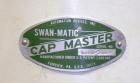 Used Swan-Matic Cap Master Single Cycle Bench Top Capper, Model C300. Up to 40 caps per minute. Driven by a 1/4 hp, 90 volt, 1750 rpm DC motor with a Swan-Matic model C302E controller. Manual adjusta...