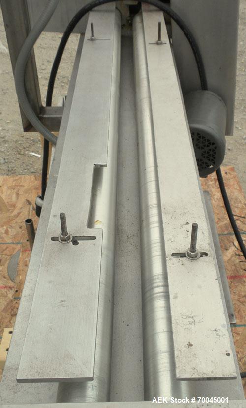 Used Holmatic Horizontal Overcapper/Lidder, stainless/aluminum construction, model PH-31. Last running 211 lids. 46" long single lane rollers, driven by a 1/4 hp, 3/60/230/460 volt, 1725 rpm motor. R...