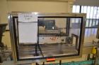 Used Fragrance Overlid snap capper. Unit was designed with top compression belt to gradually snap on overlids or caps to Fragrance containers. Last used in a complete MRM Elgin fragrance filling line.