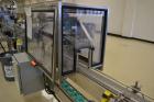 Used Fragrance Overlid snap capper. Unit was designed with top compression belt to gradually snap on overlids or caps to Fragrance containers. Last used in a complete MRM Elgin fragrance filling line.