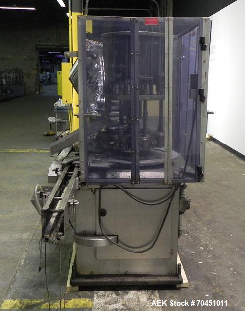 Used Anderson Model C-800 8-Head Rotary Pump Placer and Crimper for fragrance, perfume and cologne. Aluminum body finger pump sprayers crimped to glass containers. Has PMC model MM36 valve stem sorte...