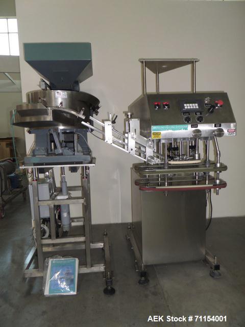 Used Inline Filling Systems Capper.  110V, 60 cycle.  Includes hopper and quality feeder Model 21CCW.  Manufactured 2002.