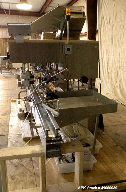 Used Kalish High Speed In Line Capper, 8 Quill, Model 5005, Stainless Steel. Last running 0 to 7-1/2" 946 ml bottles. Dual bottle feed belts. Includes a Kalish cap elevator, model 5650. Driven by a 1...