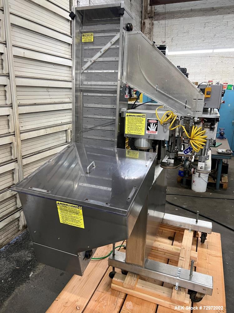 Used Kapsall Model A2 Inline Screw Capper. Capable of speeds up to 150 bottles per minute. Has single bottle grippers, three pair spindles  with adjustable cap chute and integrated cap elevator. Cap ...