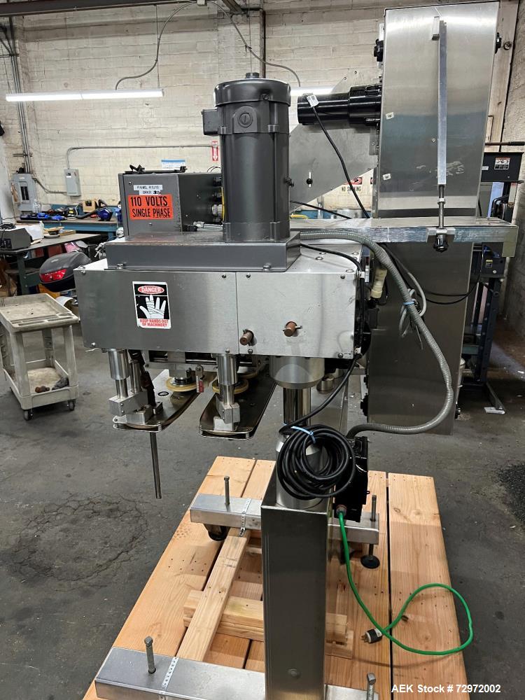 Used Kapsall Model A2 Inline Screw Capper. Capable of speeds up to 150 bottles per minute. Has single bottle grippers, three pair spindles  with adjustable cap chute and integrated cap elevator. Cap ...