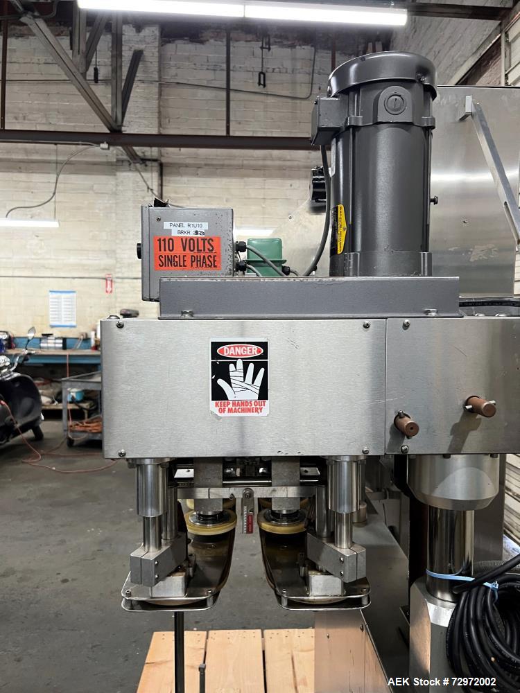 Used Kapsall Model A2 Inline Screw Capper. Capable of speeds up to 150 bottles per minute. Has single bottle grippers, three pair spindles  with adjustable cap chute and integrated cap elevator. Cap ...