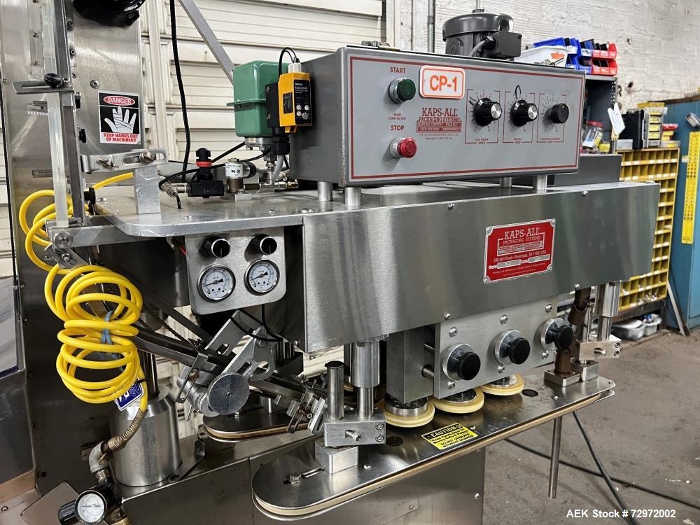 Used Kapsall Model A2 Inline Screw Capper. Capable of speeds up to 150 bottles per minute. Has single bottle grippers, three pair spindles  with adjustable cap chute and integrated cap elevator. Cap ...