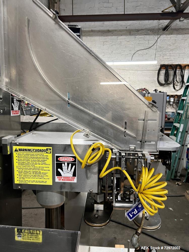 Used Kapsall Model A2 Inline Screw Capper. Capable of speeds up to 150 bottles per minute. Has single bottle grippers, three pair spindles  with adjustable cap chute and integrated cap elevator. Cap ...