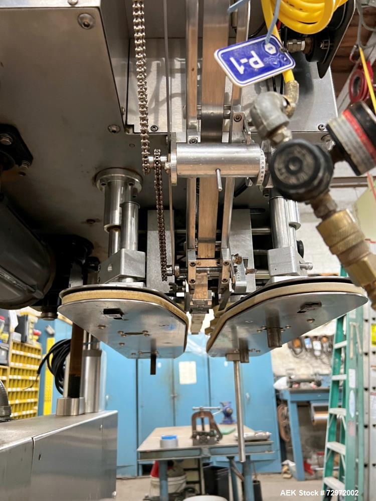 Used Kapsall Model A2 Inline Screw Capper. Capable of speeds up to 150 bottles per minute. Has single bottle grippers, three pair spindles  with adjustable cap chute and integrated cap elevator. Cap ...