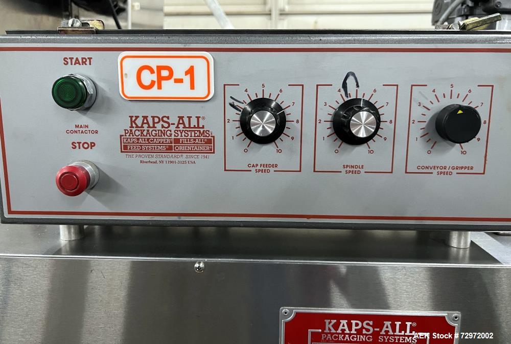 Used Kapsall Model A2 Inline Screw Capper. Capable of speeds up to 150 bottles per minute. Has single bottle grippers, three pair spindles  with adjustable cap chute and integrated cap elevator. Cap ...