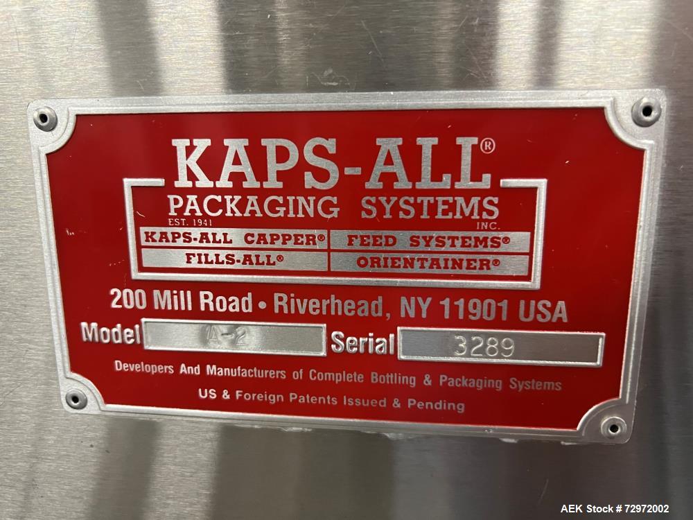 Used Kapsall Model A2 Inline Screw Capper. Capable of speeds up to 150 bottles per minute. Has single bottle grippers, three pair spindles  with adjustable cap chute and integrated cap elevator. Cap ...