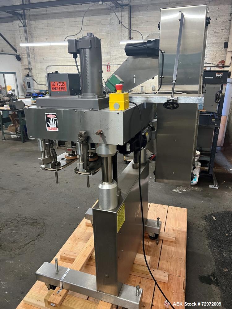 Used Kapsall Model A 2Inline Screw Capper. Capable of speeds up to 150 bottles per minute. Has single bottle grippers, three pair spindles  with adjustable cap chute and integrated cap elevator. Cap ...
