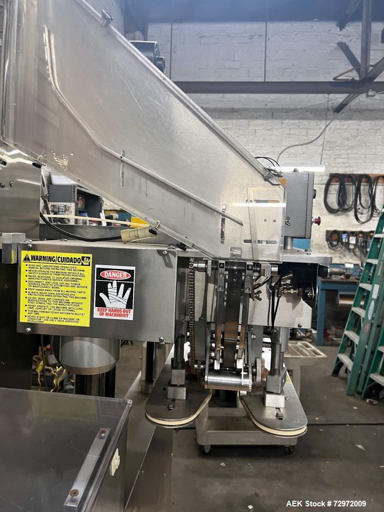 Used Kapsall Model A 2Inline Screw Capper. Capable of speeds up to 150 bottles per minute. Has single bottle grippers, three pair spindles  with adjustable cap chute and integrated cap elevator. Cap ...