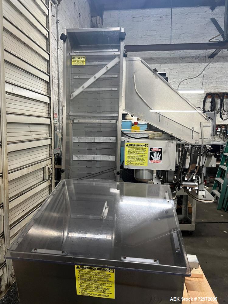 Used Kapsall Model A 2Inline Screw Capper. Capable of speeds up to 150 bottles per minute. Has single bottle grippers, three pair spindles  with adjustable cap chute and integrated cap elevator. Cap ...