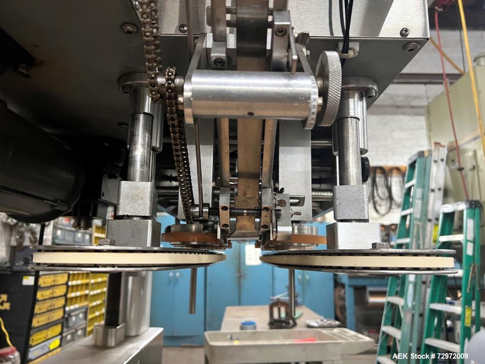 Used Kapsall Model A 2Inline Screw Capper. Capable of speeds up to 150 bottles per minute. Has single bottle grippers, three pair spindles  with adjustable cap chute and integrated cap elevator. Cap ...