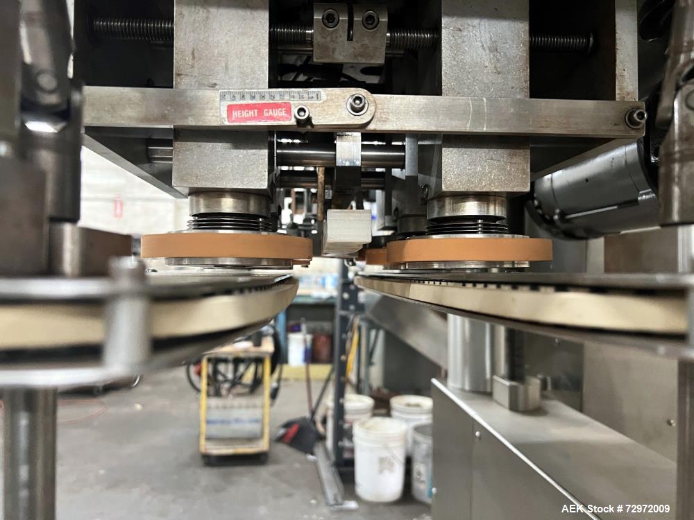 Used Kapsall Model A 2Inline Screw Capper. Capable of speeds up to 150 bottles per minute. Has single bottle grippers, three pair spindles  with adjustable cap chute and integrated cap elevator. Cap ...