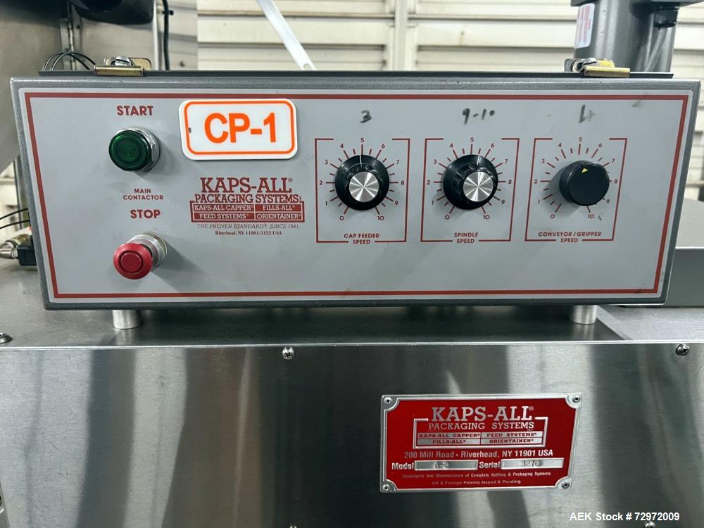 Used Kapsall Model A 2Inline Screw Capper. Capable of speeds up to 150 bottles per minute. Has single bottle grippers, three pair spindles  with adjustable cap chute and integrated cap elevator. Cap ...