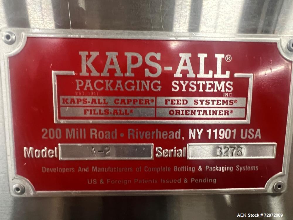 Used Kapsall Model A 2Inline Screw Capper. Capable of speeds up to 150 bottles per minute. Has single bottle grippers, three pair spindles  with adjustable cap chute and integrated cap elevator. Cap ...