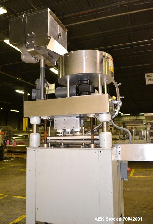 Used Kapsall Model A Inline Screw Capper. Capable of speeds up to 200 bottles per minute. Has dual bottle grippers, three pair spindles and 24" dia centrifigal cap sorter with adjustable cap chute. C...