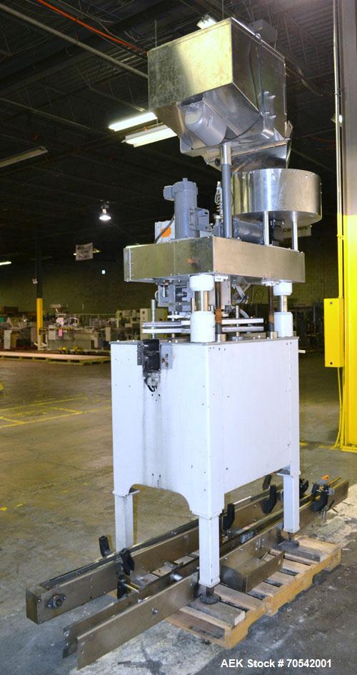 Used Kapsall Model A Inline Screw Capper. Capable of speeds up to 200 bottles per minute. Has dual bottle grippers, three pair spindles and 24" dia centrifigal cap sorter with adjustable cap chute. C...