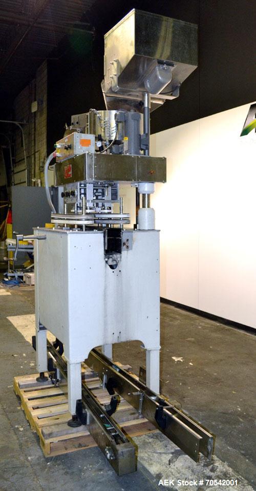 Used Kapsall Model A Inline Screw Capper. Capable of speeds up to 200 bottles per minute. Has dual bottle grippers, three pair spindles and 24" dia centrifigal cap sorter with adjustable cap chute. C...