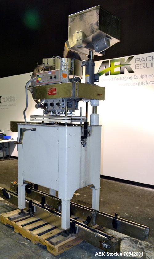 Used Kapsall Model A Inline Screw Capper. Capable of speeds up to 200 bottles per minute. Has dual bottle grippers, three pair spindles and 24" dia centrifigal cap sorter with adjustable cap chute. C...