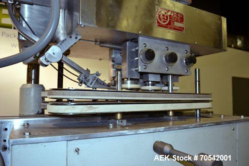 Used Kapsall Model A Inline Screw Capper. Capable of speeds up to 200 bottles per minute. Has dual bottle grippers, three pair spindles and 24" dia centrifigal cap sorter with adjustable cap chute. C...