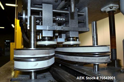 Used Kapsall Model A Inline Screw Capper. Capable of speeds up to 200 bottles per minute. Has dual bottle grippers, three pair spindles and 24" dia centrifigal cap sorter with adjustable cap chute. C...