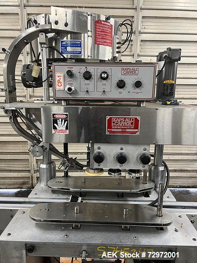 Used- Kapsall Model A Inline Screw Capper. Capable of speeds up to 200 bottles per minute. Has single bottle grippers, three...