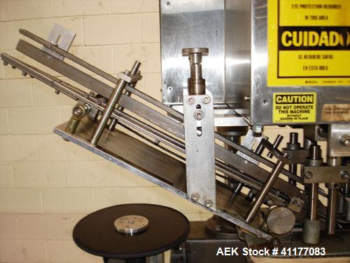 Used SureKap 3 Spindle Quill Capper, Model SK6000-SP18M. Adjustable chute will handle caps from 13 to 110mm without change parts. Has dual gripper belts, C frame construction will mount up to any con...
