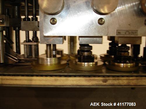 Used SureKap 3 Spindle Quill Capper, Model SK6000-SP18M. Adjustable chute will handle caps from 13 to 110mm without change parts. Has dual gripper belts, C frame construction will mount up to any con...