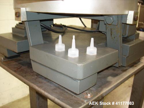 Used SureKap 3 Spindle Quill Capper, Model SK6000-SP18M. Adjustable chute will handle caps from 13 to 110mm without change parts. Has dual gripper belts, C frame construction will mount up to any con...