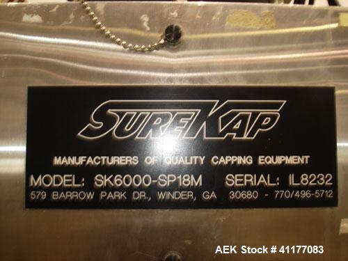 Used SureKap 3 Spindle Quill Capper, Model SK6000-SP18M. Adjustable chute will handle caps from 13 to 110mm without change parts. Has dual gripper belts, C frame construction will mount up to any con...
