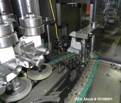 Used Resina Model NRU51 High Speed Automatic Inline Quill Capper. Machine is capable of speeds up to 300 bpm. Cap size range: 10mm to 89mm with changeparts. Equipped with dual belt gripper, H26 exten...