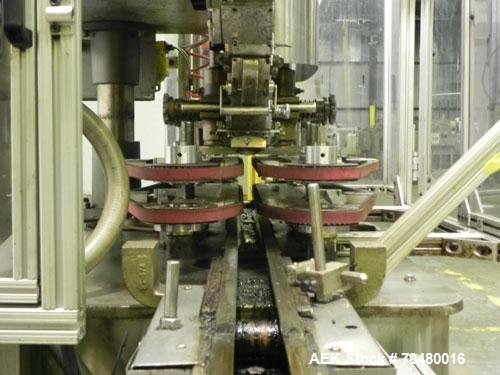 Used Resina Model U40-663 Automatic Inline Capper. Machine is capable of speeds up to 300 caps per minute. Adjustable from 10mm-70mm caps. Has top mounted cap sorter with hopper. Machine has 2HR pin ...