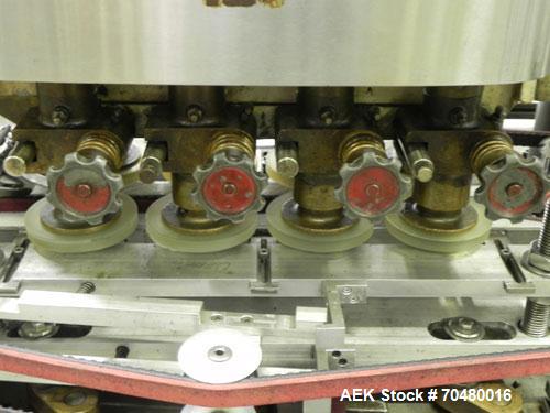 Used Resina Model U40-663 Automatic Inline Capper. Machine is capable of speeds up to 300 caps per minute. Adjustable from 10mm-70mm caps. Has top mounted cap sorter with hopper. Machine has 2HR pin ...